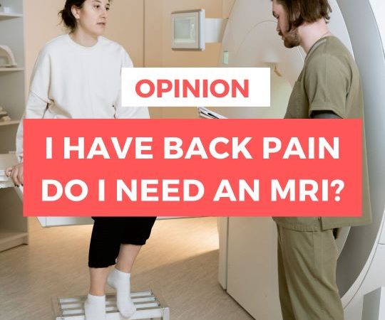 A patient is seen sitting on an MRI scanner talking to a doctor