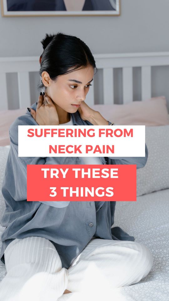 Woman on bed holding her neck in pain